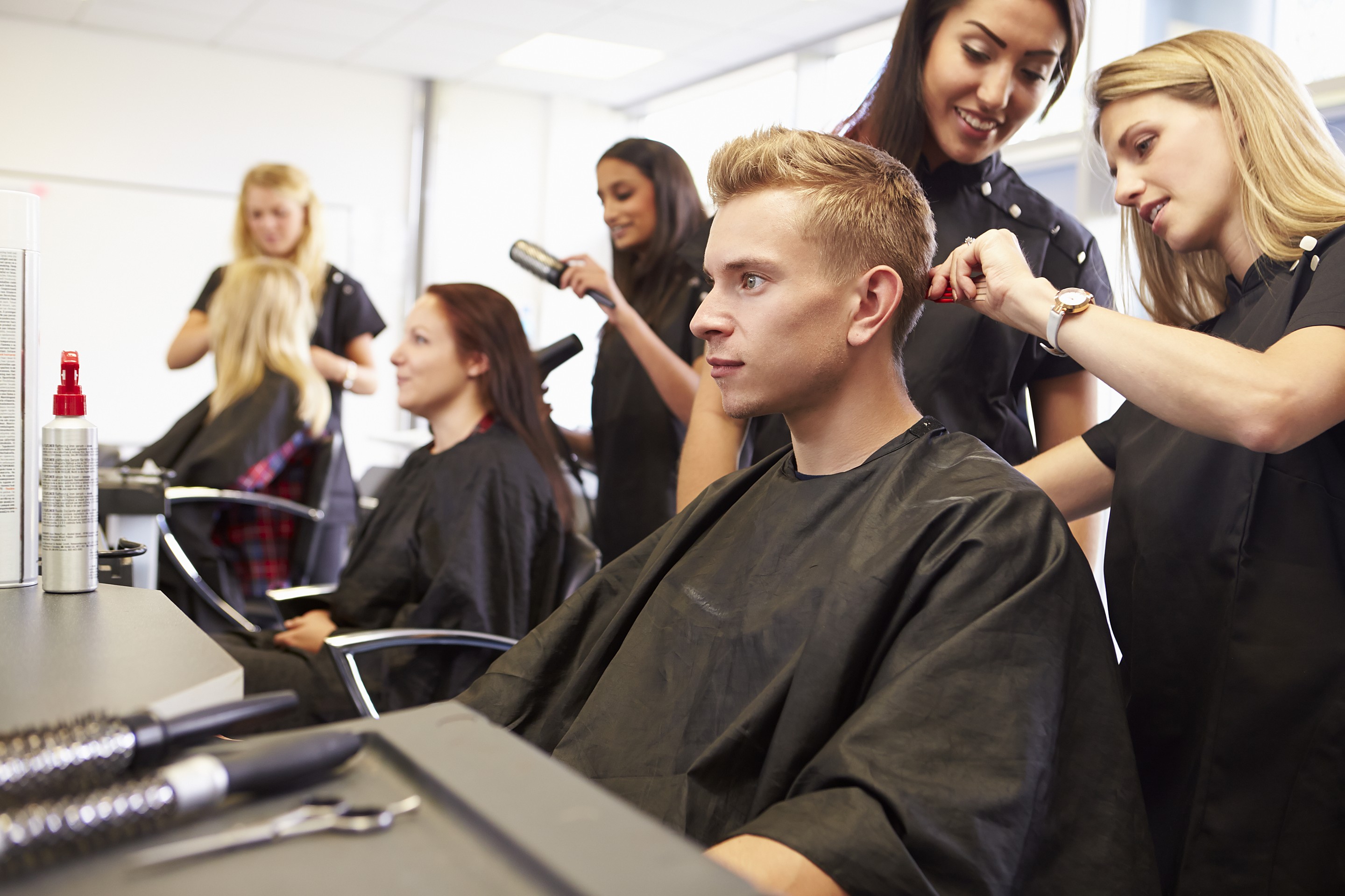 Clwydian Academy students cutting, colouring and finishing for live models on the training floor